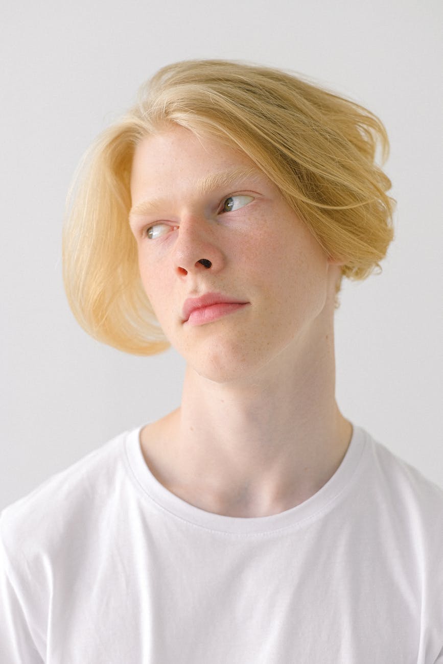 thoughtful teenage boy with stylish haircut